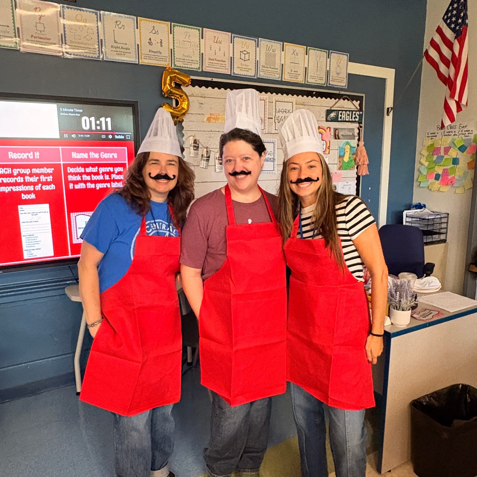 Central School teachers embrace the restaurant theme with chef hats and aprons.
